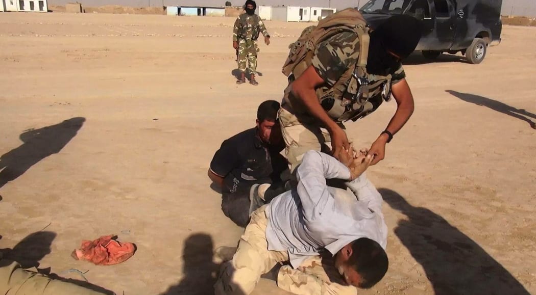 An image made available by the jihadist Twitter account Al-Baraka news  allegedly shows Islamic State of Iraq and Syria militants (ISIS) restraining an unidentified man at an undisclosed location close to the Iraqi-Syrian border, in the district of Sinjar, northwest Iraq.