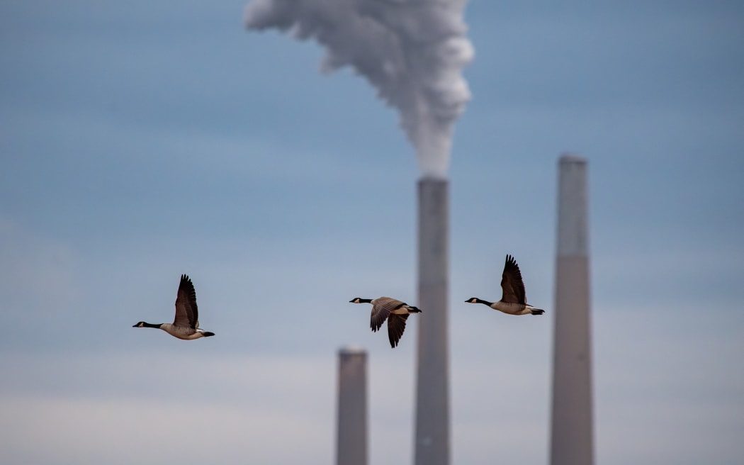 Pollution and steam rise from the stacks of the Miami Fort Power Station, which is situated along the Ohio River near Cincinnati, Ohio, on 2 November, 2025.