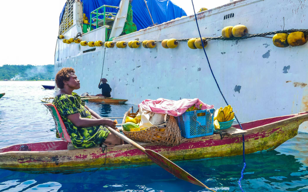Traders by the vessels side in Papua New Guinea.