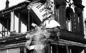 Originally built by Thomas Mason for his chemist shop, this was later taken over by pharmacist John Valentine Gordon. When the earthquake struck in June 1942, the building was extensively damaged and had to be demolished. Today it is the site of Hannahs.
* Photograph supplied by the Wairarapa Archive. The Wairarapa Archive is situated at 44 Queen St, Masterton, and is open every weekday afternoon. The archive’s collection includes many thousands of heritage photographs. Over 25,000 are available to view on line at the Picture Wairarapa website http://bit.ly/1f9sXzl