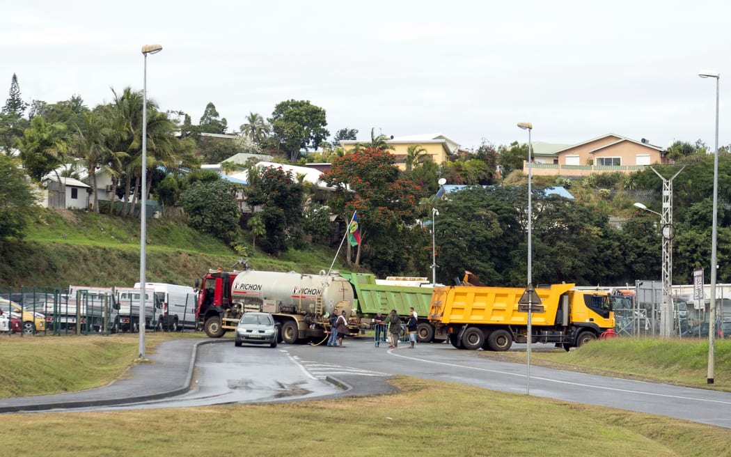Trucks block a road leading in to New Caledonia's capital, Noumea.