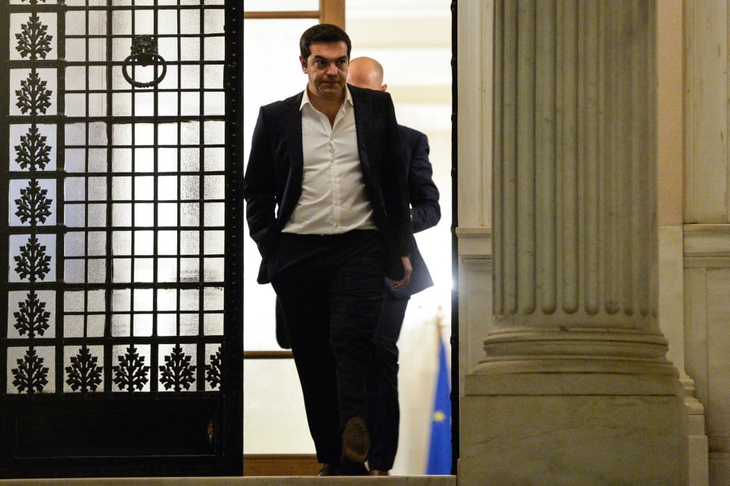 Greek Prime Minister Alexis Tsipras leaves his office after a day of political consultations in Athens on 14 July 2014.