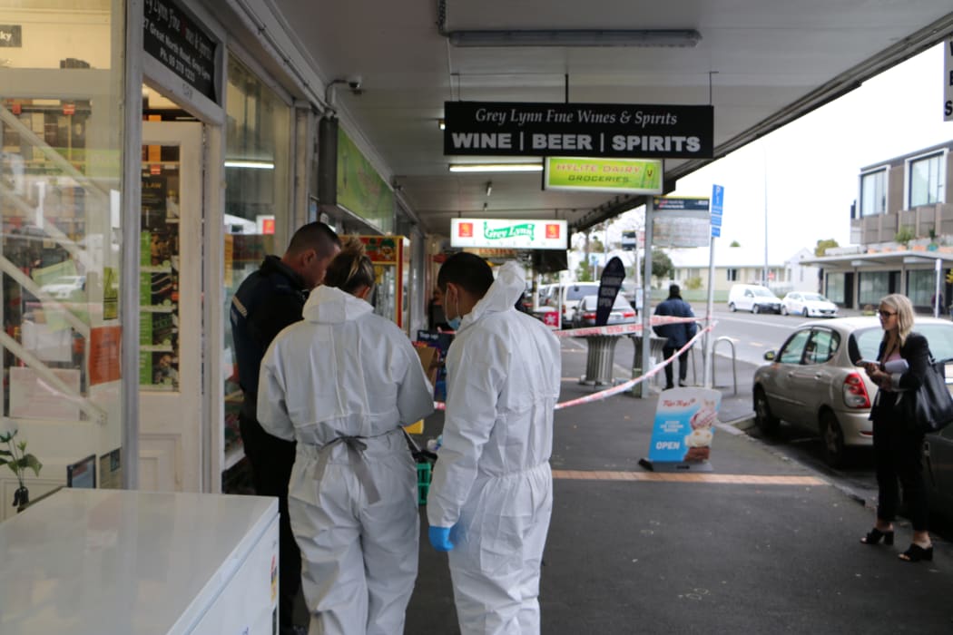 Police examine the scene after a stabbing at Grey Lynn supprette, Hylite Dairy.