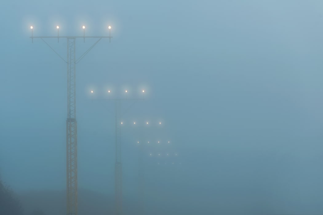 Landing lights at a airport during foggy weahter, help airplanes find the runway approach