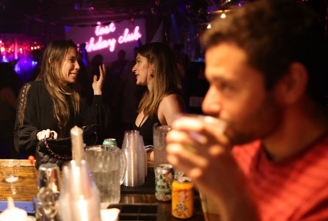 Patrons drink at the bar at DC9 nightclub during their Lost Birthday Club dance party on June 11, 2021 in Washington, DC.