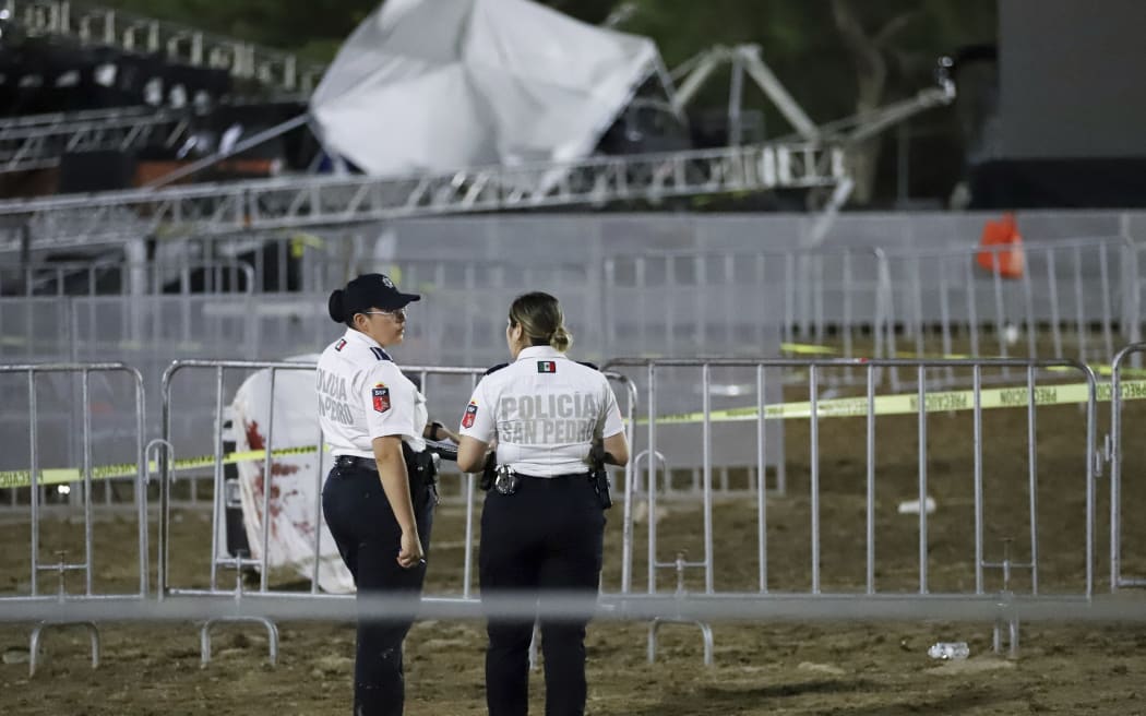 Security forces stand around a stage that collapsed due to a gust of wind during an event attended by presidential candidate Jorge Álvarez Máynez in San Pedro Garza García, on the outskirts of Monterey, Mexico, Wednesday, May 22, 2024. President Andres Manuel Lopez Obrador confirmed that four people were killed and at least a dozen were injured. (AP Photo/Alberto Lopez)