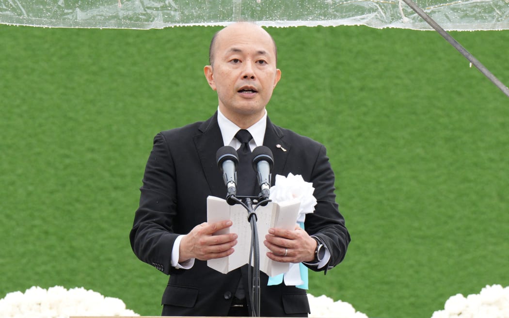 Nagasaki Mayor Shiro Suzuki notes the peace declaration, during the Nagasaki Atomic Bomb Memorial ceremony at the Nagasaki Peace Park, on 9 August 2025. Nagasaki marked the 80th year after the bombing and thousands of people attended the ceremony to offer prayers for the victims.