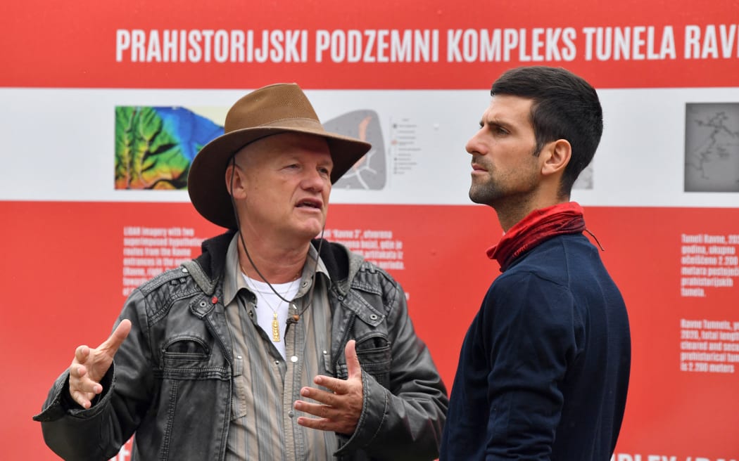 World's No.1 tennis player, Novak Djokovic (R) gets introductory explanation from Bosnian archaeological explorer, Semir Osmanagic (C), the founder of the “Archaeological Park: Bosnian Pyramid of the Sun” as he arrives at the nearby archaeological park "Ravne" near central-Bosnian town of Visoko on October 15, 2020. - This area known as the Bosnian valley of pyramids is the largest world complex of pyramidal structures and an archaeological phenomenon and is believed by some to have spiritual and healing powers. (Photo by ELVIS BARUKCIC / AFP)
