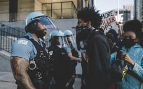 Protesters clash with police in Chicago  , on May 30, 2020 during a protest against the death of George Floyd, an unarmed black man who died while while being arrested and pinned to the ground by the knee of a Minneapolis police officer.
