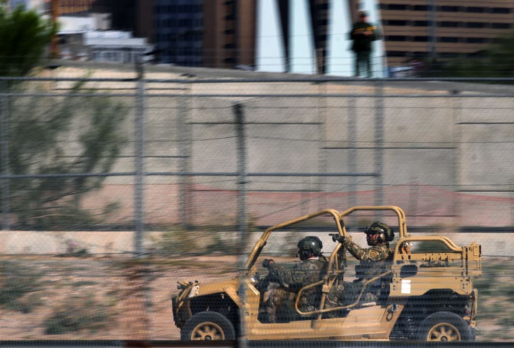 Members of the US Border Patrol tactical group hold a crowd control drill along the Rio Grande in El Paso, Texas.