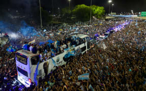 Supporters cheer the homecoming Argentina football team as the players celebrate after winning the Qatar 2022 World Cup tournament, in Ezeiza, Buenos Aires province, Argentina, on 20 December, 2022.