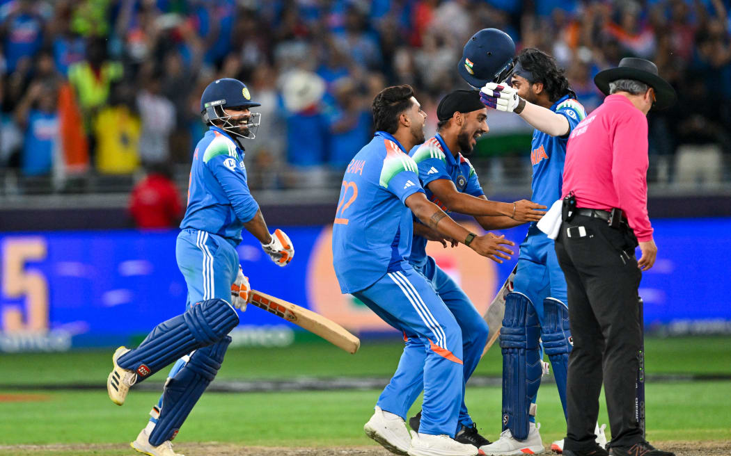 India's players celebrate victory during the ICC Champions Trophy one-day international (ODI) final cricket match between India and New Zealand at the Dubai International Stadium in Dubai on 9 March 2025.