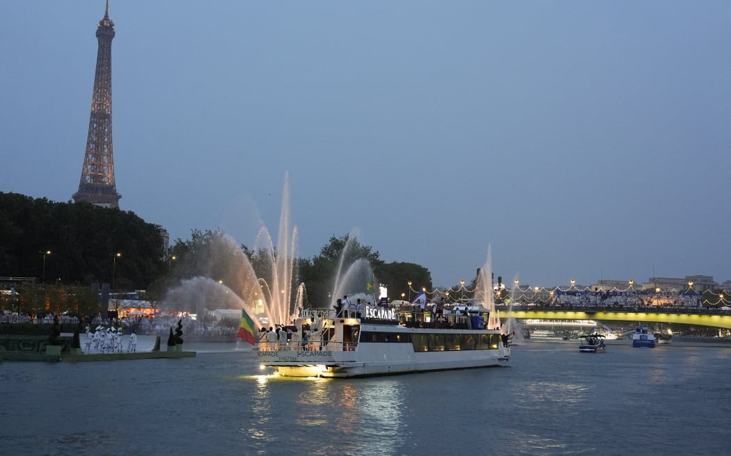 Delegations sail in boats along the river Seine during the opening ceremony of the Paris 2024 Olympic Games in Paris on July 26, 2024. (Photo by Morry Gash / POOL / AFP)