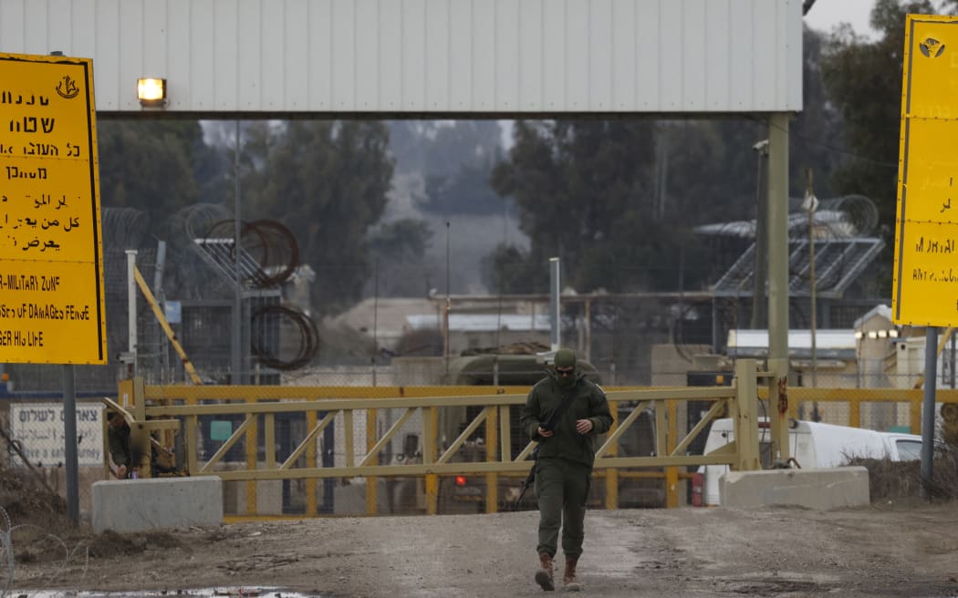 An Israeli soldier walks near the United Nations Quneitra crossing between the Israeli-annexed Golan Heights and Syria on January 5, 2025. Since the fall of Syrian president Bashar al-Assad, Israel has occupied strategic positions in a UN-patrolled buffer zone between Syria and the Israeli-annexed Golan Heights which it seized in the 1967 Arab-Israeli war. (Photo by Jalaa MAREY / AFP)
