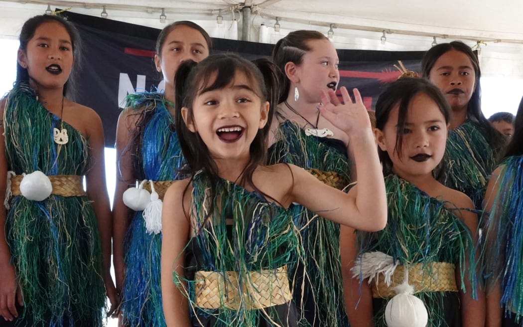 Five-year-old Amokura Te Puhi Atama, of Te Kura Kaupapa Māori o Whangaroa, spots her mum in the audience.