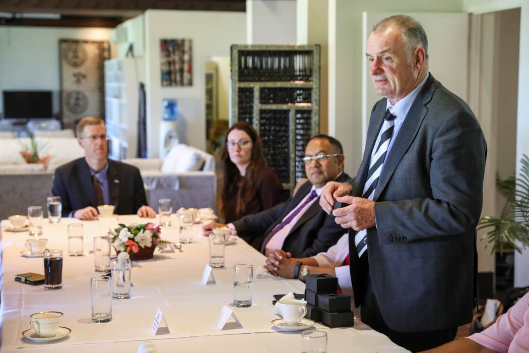 New Zealand's Speaker Trevor Mallard presents the Fiji Women MPs with a camellia brooch. The camellia flower is a symbol of women's suffrage.