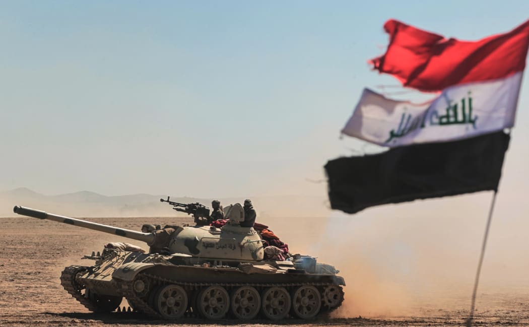 Tanks and armoured vehicles of the Iraqi forces, supported by the Hashed al-Shaabi (Popular Mobilisation) paramilitaries, advance towards the village of Sheikh Younis, south of Mosul, after the offensive to retake the western side of Mosul from Islamic State (IS) commenced on 19 February 2017.