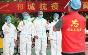 Local citizens line up while keeping social distance at a test center in Gaoxin District of Yangzhou City, east China's Jiangsu Province, 11 August 2021.