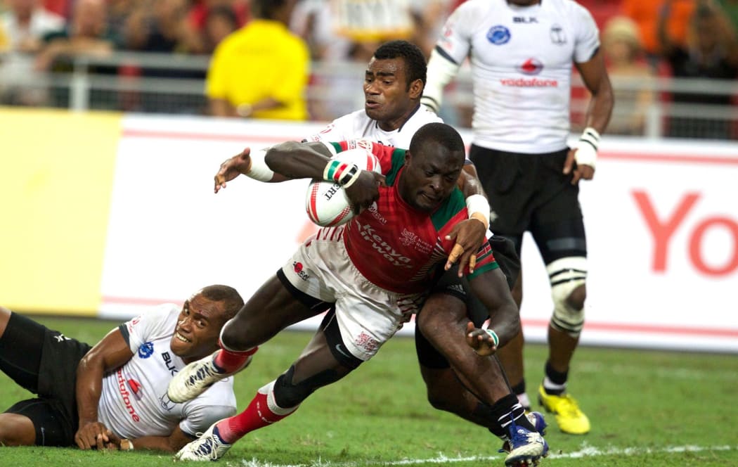 Man of the match Collins Injera scores in Kenya's Cup final win against Fiji.