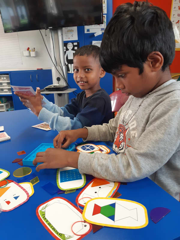 Children learn maths through card games and puzzles.