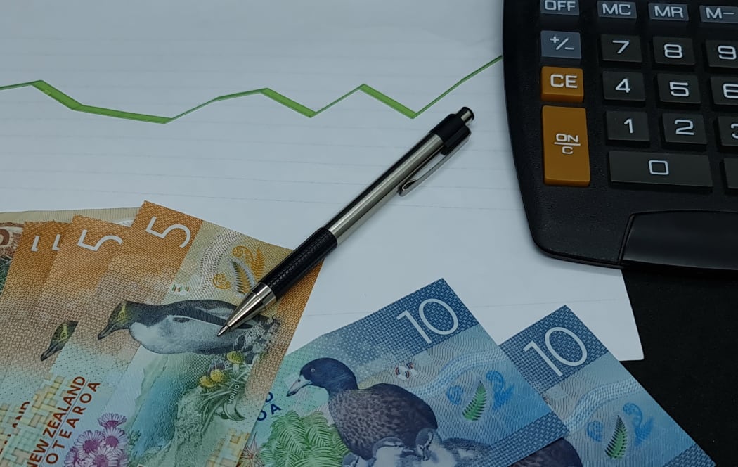 New Zealand banknotes, pen and calculator on background with rising trend green line