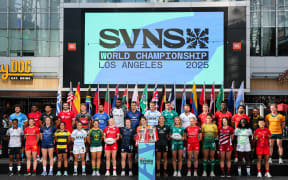 Men's and women's Rugby Sevens team captains gather for the captains' photo with the Championship trophies ahead of the 2025 HSBC Rugby Sevens LA tournament World Championship at LA Live in Los Angeles, California on April 30, 2025. (Photo by Patrick T. Fallon / AFP)