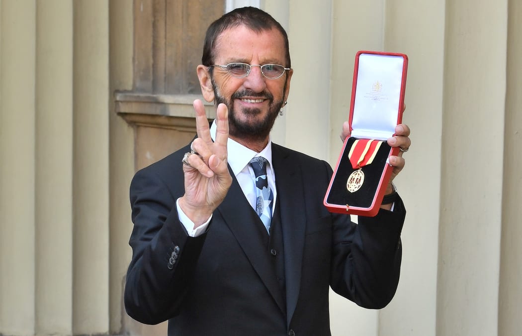 Richard Starkey, better known as Ringo Starr, poses with his medal after being appointed Knight Commander of the Order of the British Empire at an investiture ceremony at Buckingham Palace in London.