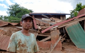 Devestation in Thahin village after the collapse of an under-construction dam in south-east Laos.

Mr. Khambone in front of the remains of his house.