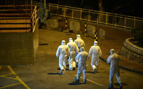 Medical personnel wearing protective suits in Hong Kong, early on February 11, 2020, after two people in the area were confirmed to have the coronavirus according to local newspaper reports.