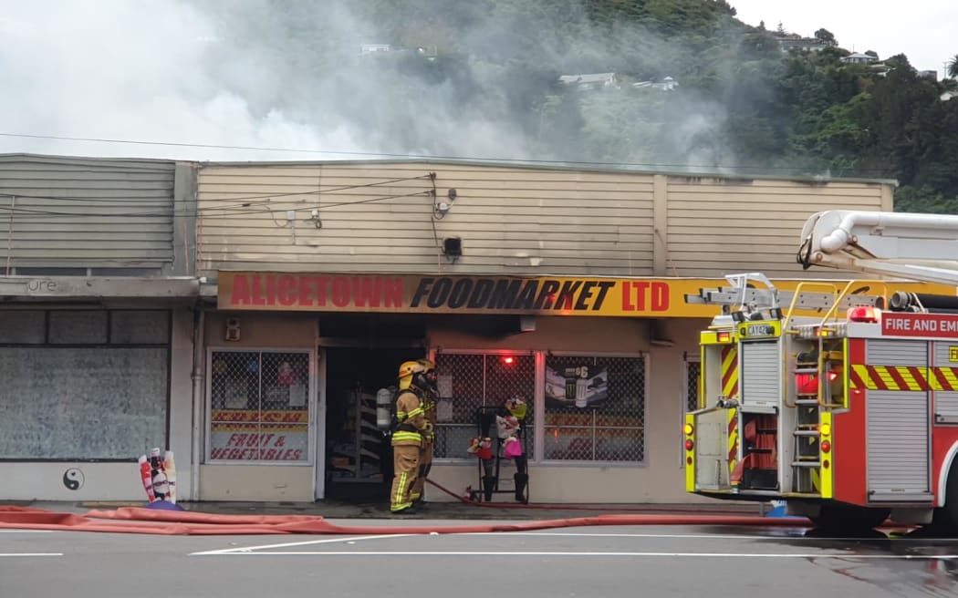 Firefighters outside the Alicetown Foodmarket, Lower Hutt, 18 April 2023.