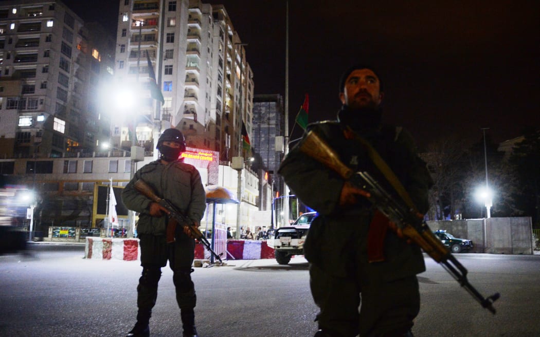Police stand guard outside the Serena hotel in Kabul on Thursday.