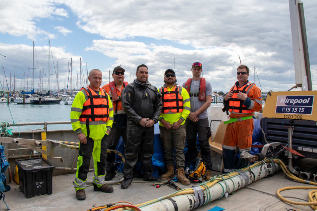 Workers get ready to fix a sewage pipe in Nelson which is leaking into the ocean.