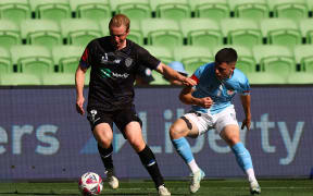 MELBOURNE, AUSTRALIA - DECEMBER 15: Francis De Vries of Auckland FC (L) is challenged during the round eight A-League Men match between Melbourne City and Auckland FC at AAMI Park on December 15, 2024 in Melbourne, Australia. (Photo by Graham Denholm/Getty Images)