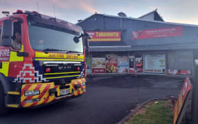 A fire truck outside burned-out businesses on Great South Road in Takanini.