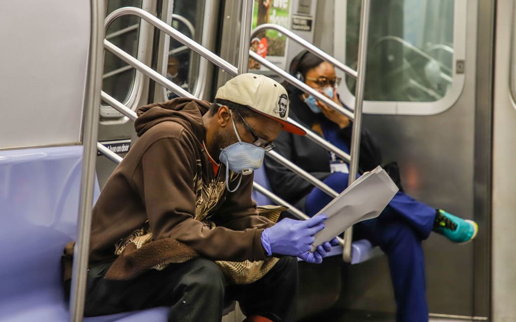 New York metro passengers and staff are visas wearing protective masks during the COVID-19 coronavirus pandemic in the United States.