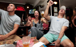 Ed Newaly from massachusetts, Heather Newaly from Hawaii and Keawe Holt from Hawaii watching the superbowl final at shakespeare bar (Auckland)