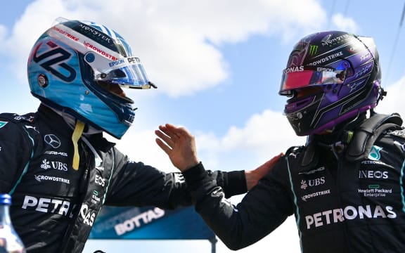 Mercedes' British driver Lewis Hamilton (R) congratulates Mercedes' Finnish driver Valtteri Bottas for his pole position after the qualifying session of the Portuguese Formula One Grand Prix at the Algarve International Circuit in Portimao on May 1, 2021.
