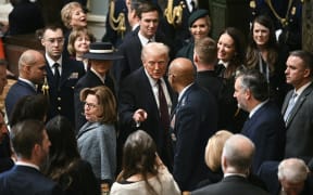 US President Donald Trump gestures as he departs a luncheon following the inauguration ceremony, in Statuary Hall at the US Capitol in Washington, DC, on January 20, 2025. (Photo by Brendan SMIALOWSKI / AFP)