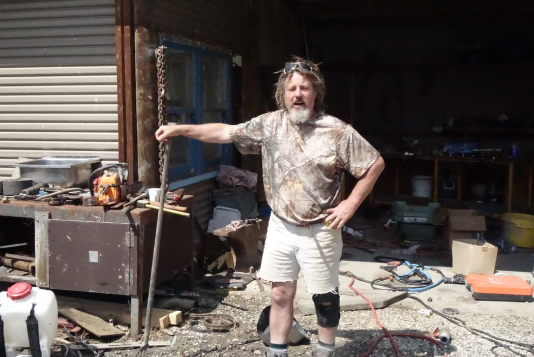 Alan Parker of Miller's Flat standing in his shed.