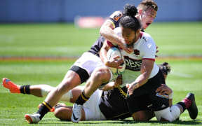 North Harbour's Matt Vaega is tackled by Wellington's Wes Goosen.