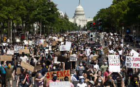 Protesters demonstrate over the death of George Floyd, by a Minneapolis police officer, at a rally on May 30, 2020 in Washington, DC. - Demonstrations are being held across the US after George Floyd died in police custody on May 25. (Photo by Jose Luis Magana / AFP)
