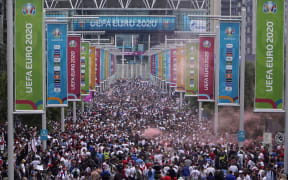 Fans gather at Wembley Stadium ahead of the Euro 2020 final football match between England and Italy in northwest London, 11 July 2021.
