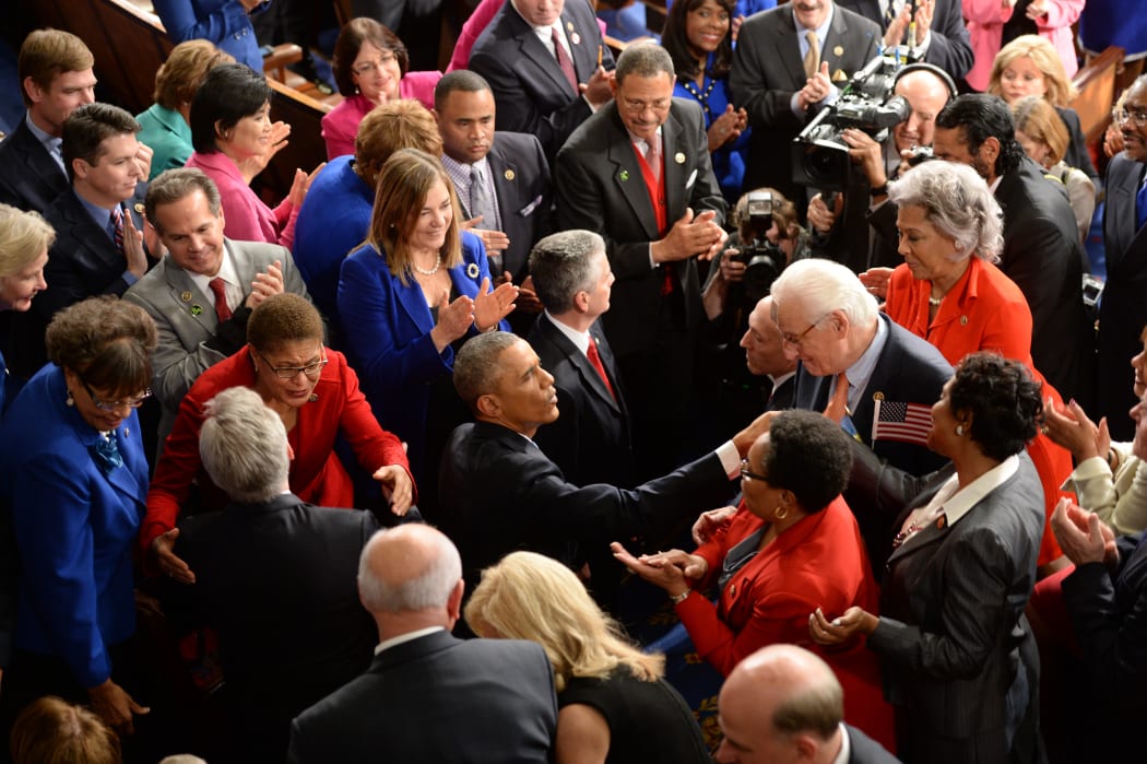 Barack Obama (C) arrives to deliver the State of The Union Address.