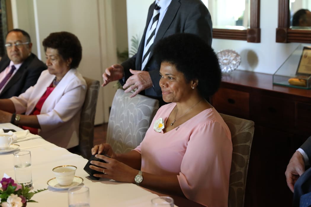 Fiji MP Lenora Qereqeretabua wearing a white camellia brooch presented to her by New Zealand's Speaker Trevor Mallard. The flower is a symbol of women's suffrage and all Fiji women MPs received one