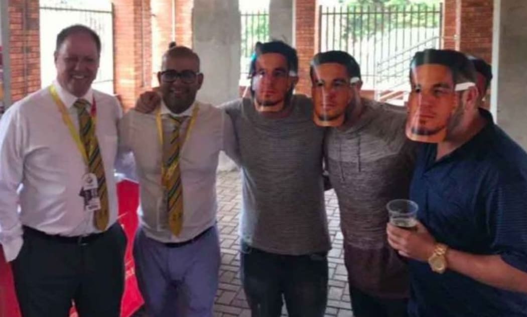 Clive Eksteen (L) and Altaaf Kazi pose with spectators wearing Sonny Bill Williams masks.