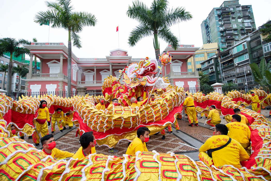 People perform a dragon dance to celebrate the Chinese Lunar New Year in Macao, south China, 1 February 2022.