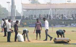 The ground staff work to keep the ground dry as toss is delayed due to wet field prior to the the Afghanistan v New Zealand Blackcaps, Day 1 of the Only Test at Greater Noida, India, 2024.