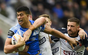Samoa's Joseph Suaali'i is tackled during the 2021 rugby league World Cup men's opening match against England in Newcastle.