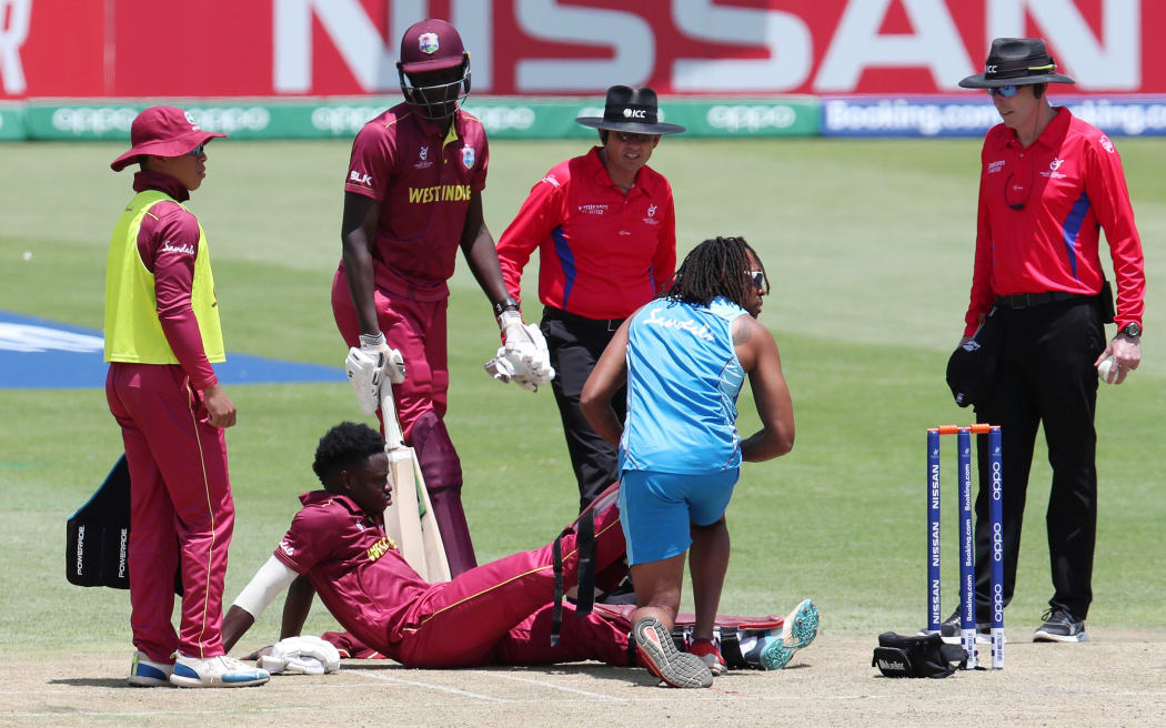 Kirk McKenzie of West Indies is treated  by medical staff after suffering severe cramp on 99.