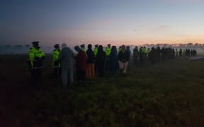 Police and protesters at dawn at Ihumātao in Auckland on 25 July 2019.